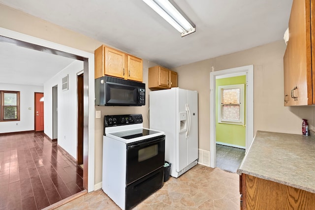 5460B W State Route 17, Kankakee, IL 60901 - kitchen with black microwave, electric stove, white fridge with ice dispenser, light countertops, and healthy amount of natural light