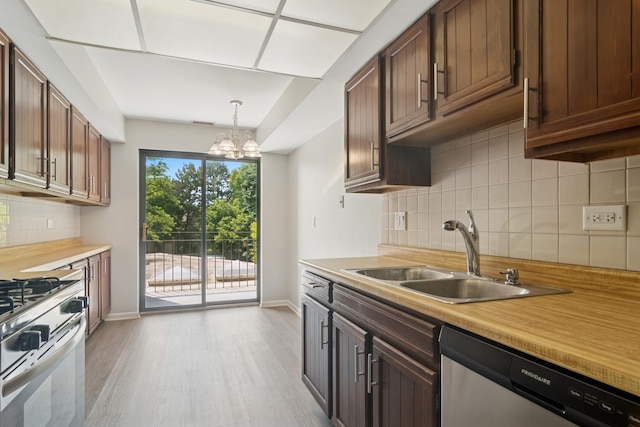 101 Old Oak Dr Unit 212, Buffalo Grove, IL 60089 - kitchen featuring dishwasher, range with gas cooktop, light countertops, light wood-type flooring, and decorative backsplash