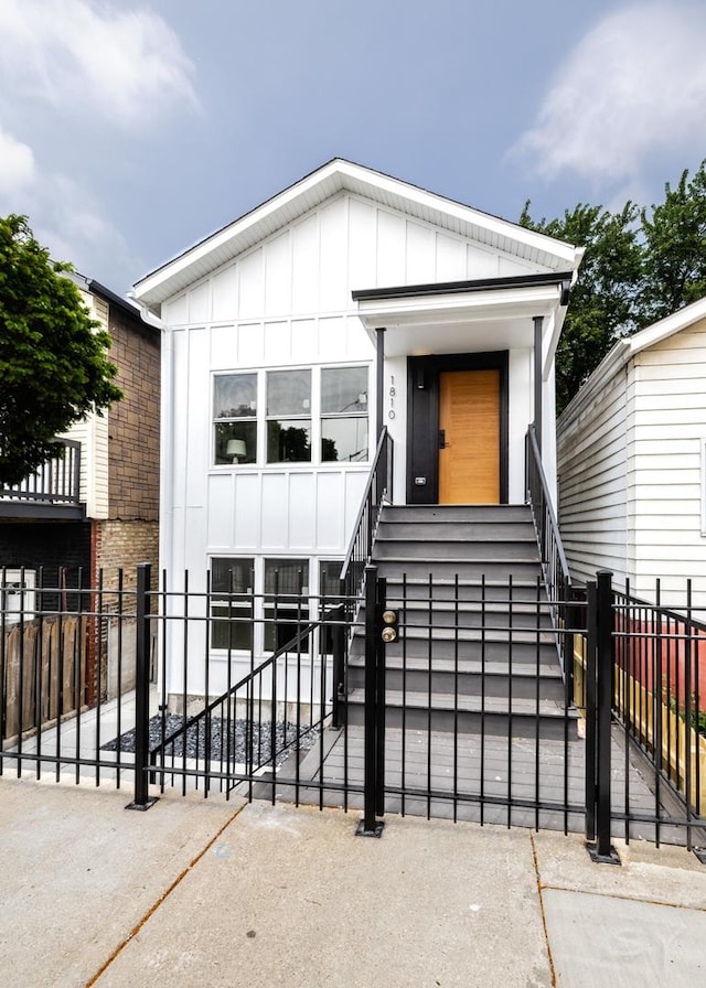 1810 W 23rd St Unit 2, Chicago, IL 60608 - view of front of home featuring board and batten siding and a fenced front yard