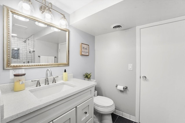 728 S Hillside Ave, Elmhurst, IL 60126 - bathroom featuring toilet, vanity, tile patterned floors, and tiled shower