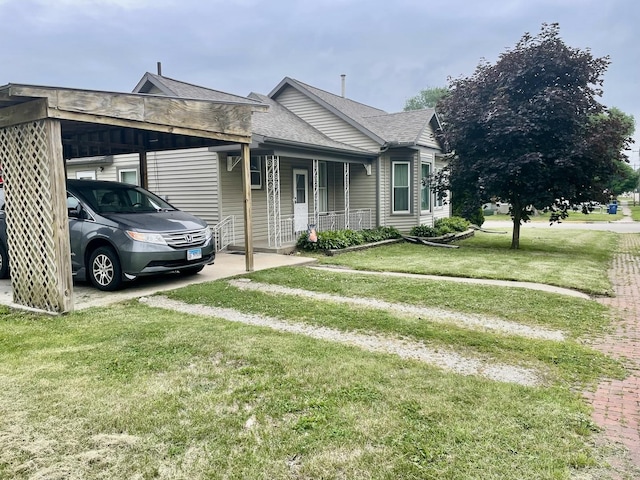 1003 3rd St, Lasalle, IL 61301 - view of front facade with a front yard, a porch, a shingled roof, and a carport