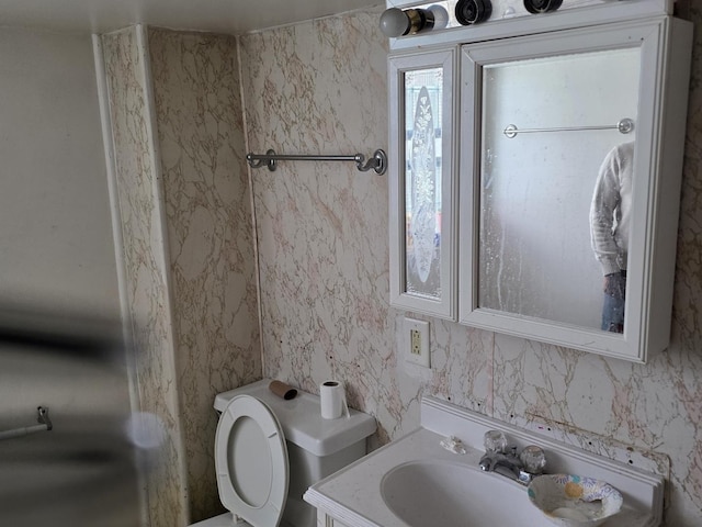 10535 S Wabash Ave, Chicago, IL 60628 - bathroom with toilet, vanity, and tile walls