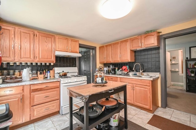 3102 Edina Blvd, Zion, IL 60099 - kitchen featuring white gas range, under cabinet range hood, tasteful backsplash, light countertops, and light brown cabinets