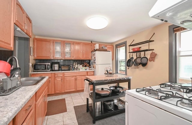 3102 Edina Blvd, Zion, IL 60099 - kitchen featuring white appliances, decorative backsplash, light countertops, glass insert cabinets, and light tile patterned flooring