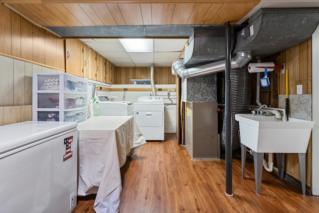 1716 Park Haven Dr, Champaign, IL 61820 - washroom with washer and dryer, wooden walls, and light wood-style floors