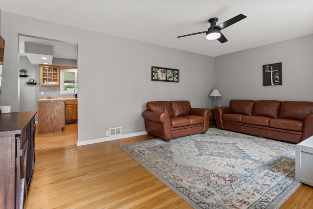 1716 Park Haven Dr, Champaign, IL 61820 - living room featuring light wood-style flooring, ceiling fan, and baseboards
