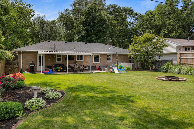 1716 Park Haven Dr, Champaign, IL 61820 - rear view of house with an outdoor fire pit, a patio area, brick siding, and a shingled roof