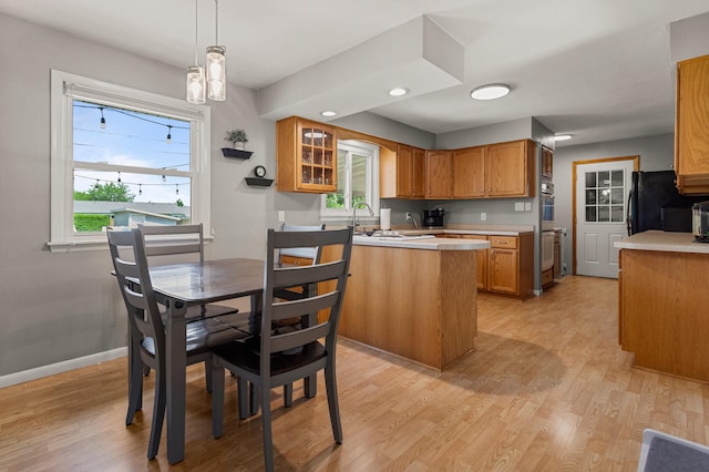 1716 Park Haven Dr, Champaign, IL 61820 - kitchen with light wood finished floors, light countertops, brown cabinets, and recessed lighting