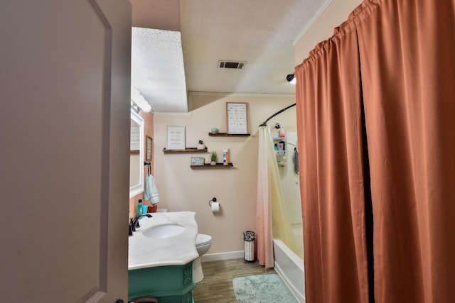 502 Short St, Cornell, IL 61319 - full bathroom with vanity, wood finished floors, shower / bath combination with curtain, and a textured ceiling