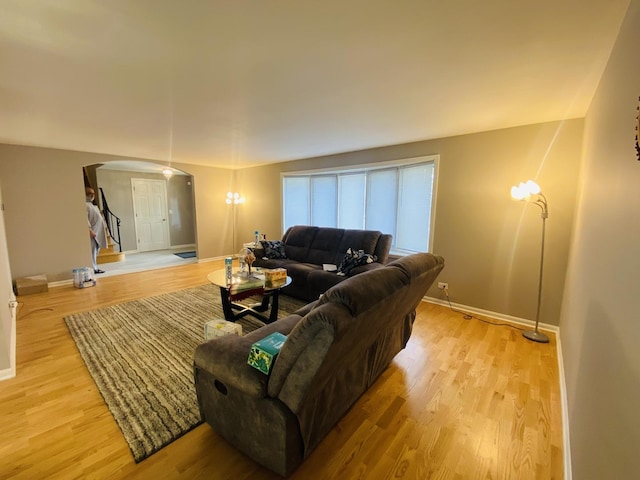 1106 Westfield Ln, Schaumburg, IL 60193 - living room with arched walkways, baseboards, and light wood-style flooring