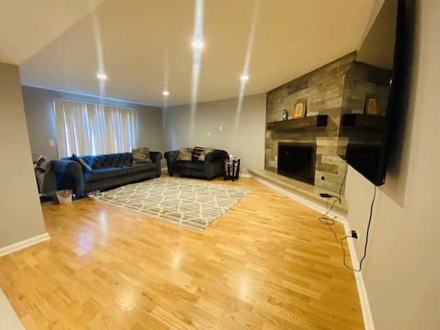 1106 Westfield Ln, Schaumburg, IL 60193 - living room featuring wood finished floors, a stone fireplace, and baseboards