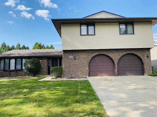 1106 Westfield Ln, Schaumburg, IL 60193 - view of front of house with brick siding, concrete driveway, an attached garage, and a front yard