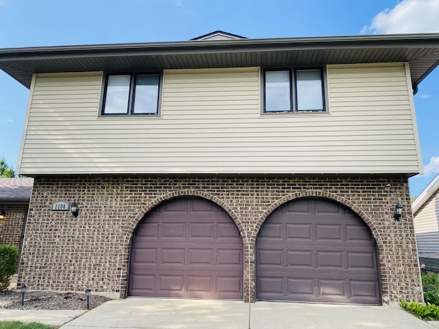1106 Westfield Ln, Schaumburg, IL 60193 - view of property exterior with a garage, driveway, and brick siding