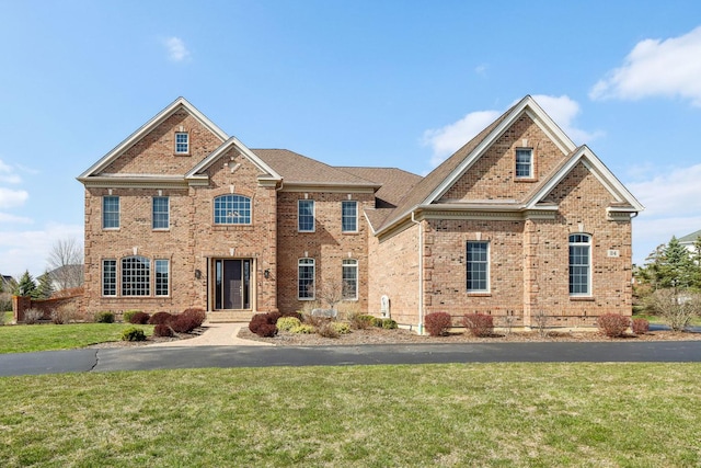 24 Wood Oaks Dr, South Barrington, IL 60010 - colonial-style house with brick siding and a front lawn