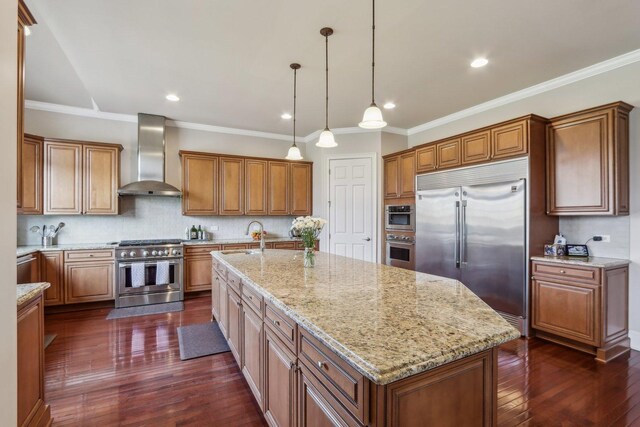 24 Wood Oaks Dr, South Barrington, IL 60010 - kitchen featuring high end appliances, wall chimney exhaust hood, a sink, brown cabinetry, and light stone countertops