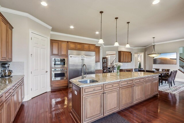 24 Wood Oaks Dr, South Barrington, IL 60010 - kitchen featuring a kitchen island with sink, a sink, dark wood-style flooring, appliances with stainless steel finishes, and decorative backsplash