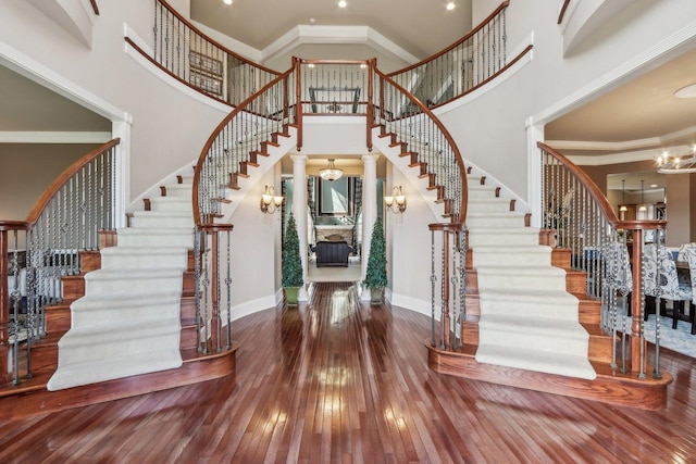 24 Wood Oaks Dr, South Barrington, IL 60010 - foyer entrance with stairs, baseboards, hardwood / wood-style flooring, a towering ceiling, and ornate columns