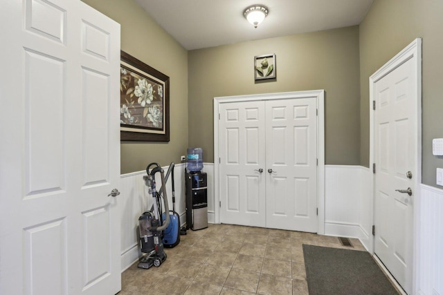 24 Wood Oaks Dr, South Barrington, IL 60010 - foyer featuring light tile patterned floors and a wainscoted wall