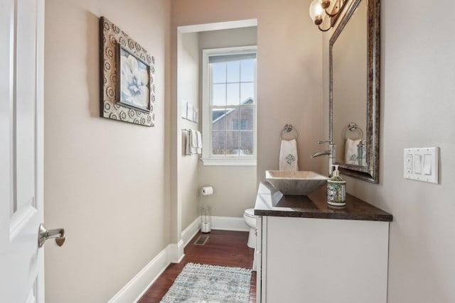 24 Wood Oaks Dr, South Barrington, IL 60010 - half bath featuring toilet, wood finished floors, vanity, and baseboards
