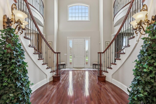 24 Wood Oaks Dr, South Barrington, IL 60010 - entryway featuring baseboards, wood-type flooring, a towering ceiling, and stairs