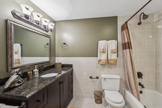 24 Wood Oaks Dr, South Barrington, IL 60010 - bathroom featuring vanity, shower / bath combo with shower curtain, toilet, tile walls, and wainscoting