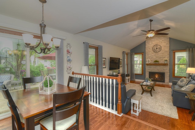 1344 Saddlebrook Rd, Bartlett, IL 60103 - dining room with a chandelier, wood finished floors, vaulted ceiling, a ceiling fan, and a stone fireplace