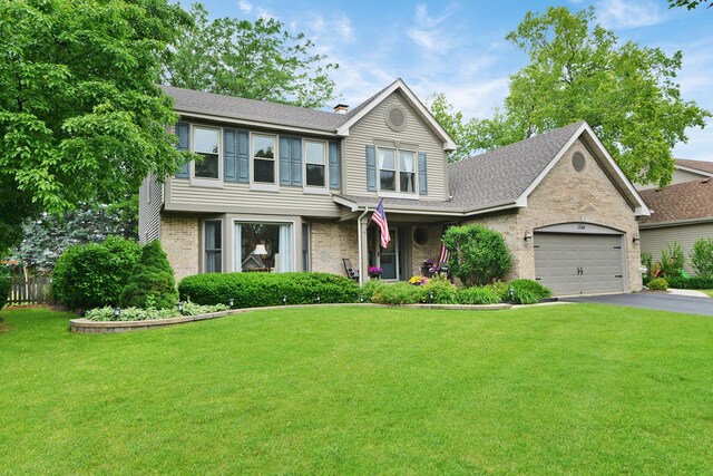1344 Saddlebrook Rd, Bartlett, IL 60103 - traditional home featuring brick siding, a front lawn, and roof with shingles