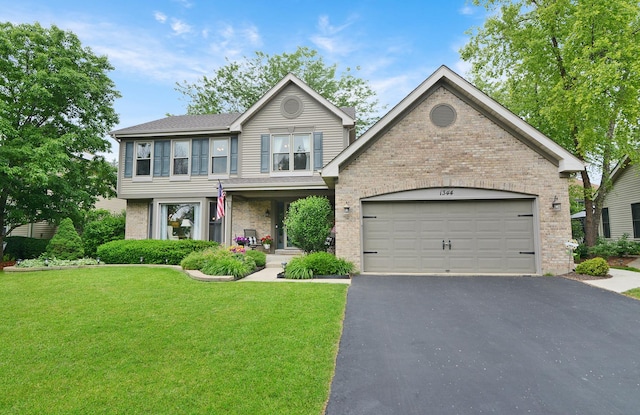 1344 Saddlebrook Rd, Bartlett, IL 60103 - view of front of property featuring brick siding, asphalt driveway, a front lawn, and an attached garage