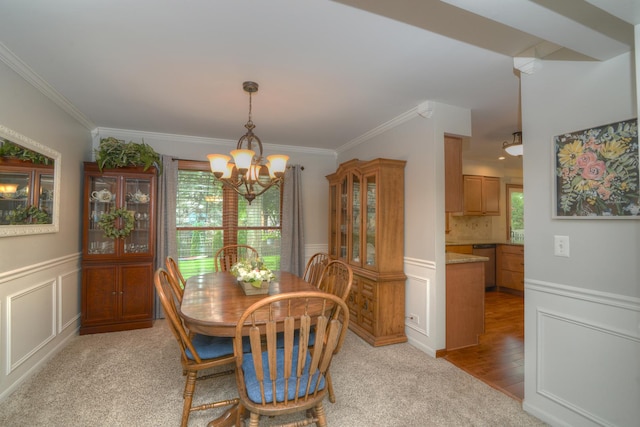 1344 Saddlebrook Rd, Bartlett, IL 60103 - dining area featuring a chandelier, healthy amount of natural light, ornamental molding, wainscoting, and a decorative wall