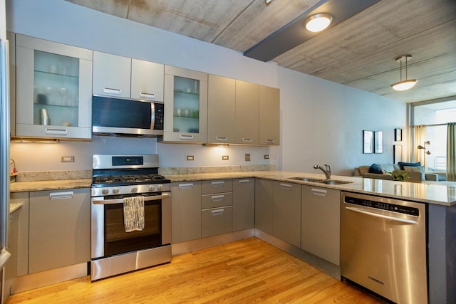 5430 N Sheridan Rd Unit 703, Chicago, IL 60640 - kitchen with appliances with stainless steel finishes, a sink, a peninsula, light wood-type flooring, and gray cabinetry