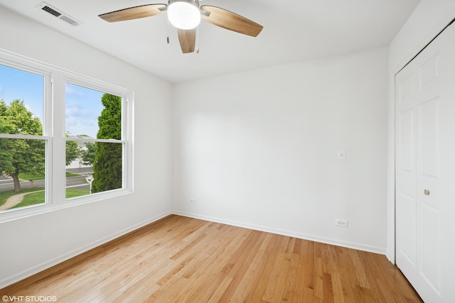 11 Litchfield Ct, Lake In The Hills, IL 60156 - unfurnished bedroom with light wood finished floors, ceiling fan, and a closet