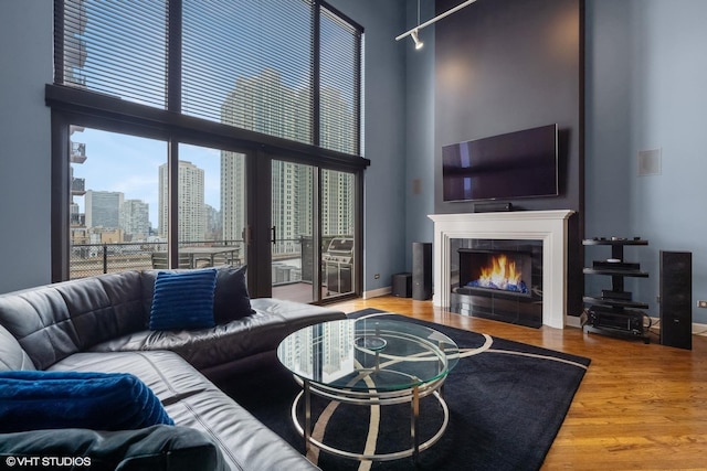 616 W Fulton St Unit 703, Chicago, IL 60661 - living area with a high ceiling, a tile fireplace, and wood finished floors