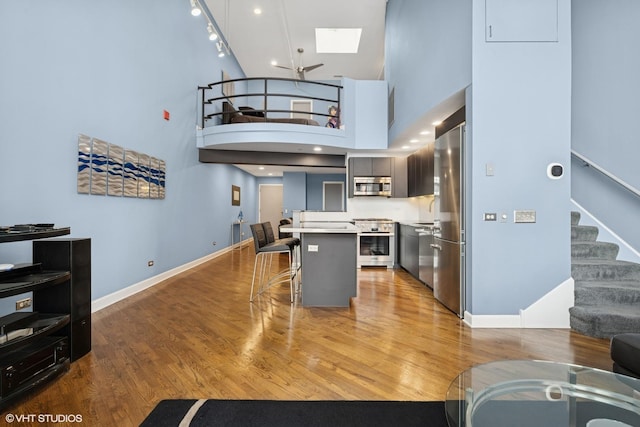 616 W Fulton St Unit 703, Chicago, IL 60661 - kitchen featuring appliances with stainless steel finishes, a breakfast bar area, a skylight, light countertops, and light wood finished floors