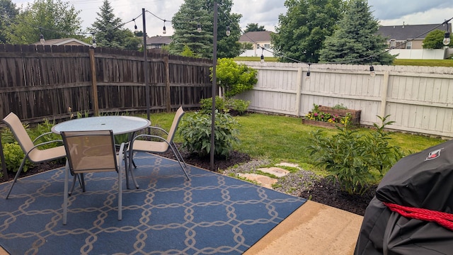 3908 Summer Sage Ct, Champaign, IL 61822 - fenced backyard featuring outdoor dining space, a patio, and a grill