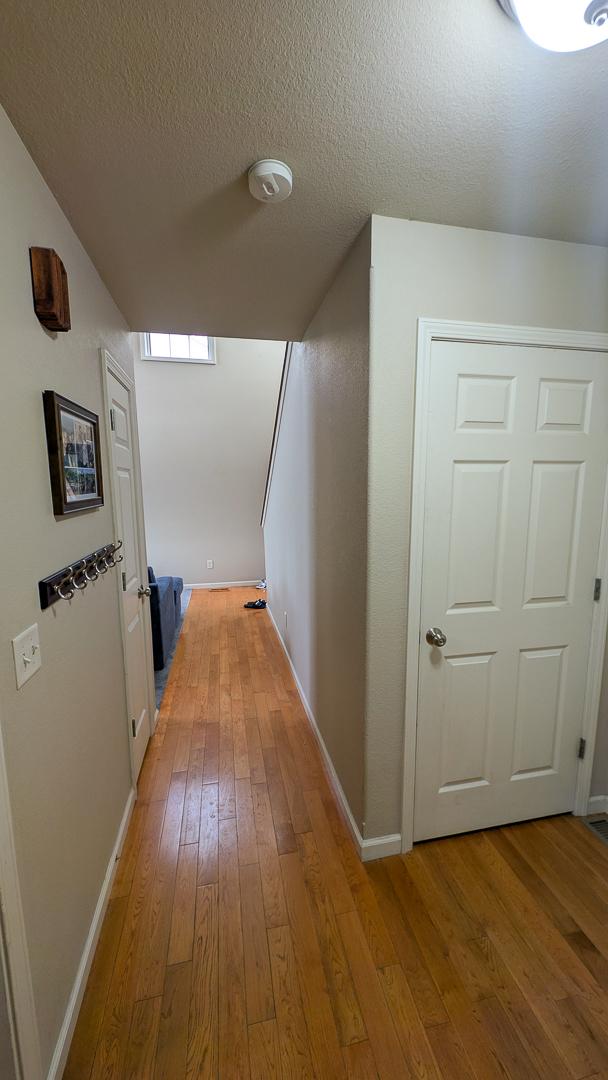3908 Summer Sage Ct, Champaign, IL 61822 - corridor with light wood-style floors and a textured ceiling