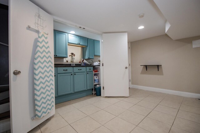 5236 W Nelson St, Chicago, IL 60641 - kitchen featuring blue cabinetry, dark countertops, light tile patterned floors, and recessed lighting