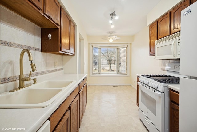 218 E Forest Knoll Dr, Palatine, IL 60074 - kitchen with white appliances, a sink, light flooring, backsplash, and light countertops