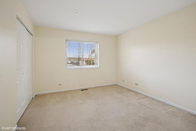 218 E Forest Knoll Dr, Palatine, IL 60074 - unfurnished bedroom with baseboards, light colored carpet, and a closet