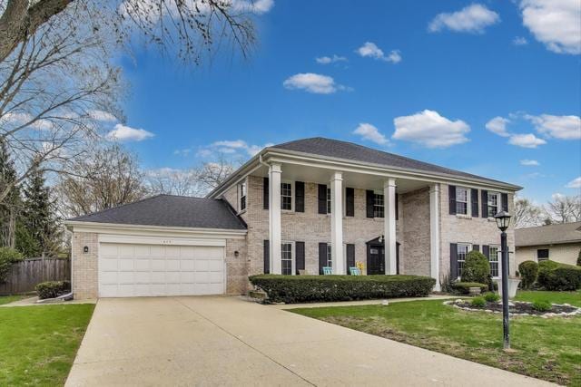 613 Michelline Ln, Northbrook, IL 60062 - neoclassical / greek revival house featuring an attached garage, driveway, and brick siding