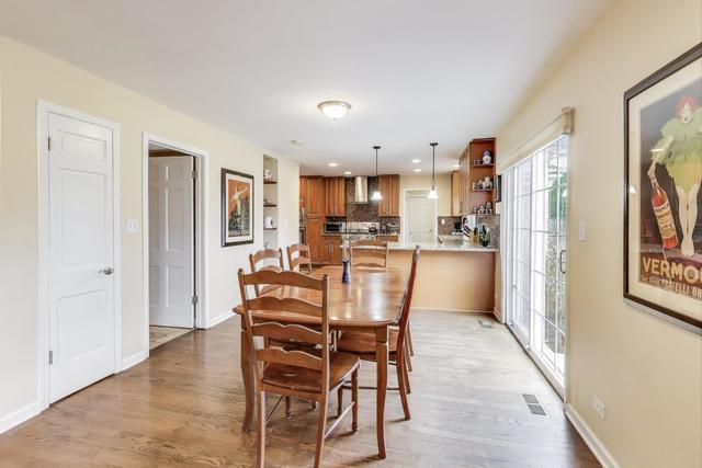 613 Michelline Ln, Northbrook, IL 60062 - dining area with light wood finished floors and baseboards