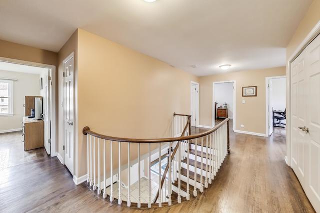 613 Michelline Ln, Northbrook, IL 60062 - corridor with an upstairs landing, wood finished floors, and baseboards