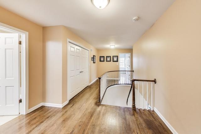 613 Michelline Ln, Northbrook, IL 60062 - hallway with an upstairs landing, wood finished floors, and baseboards