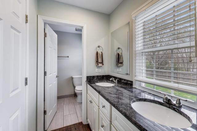 613 Michelline Ln, Northbrook, IL 60062 - full bath with double vanity, toilet, and baseboards