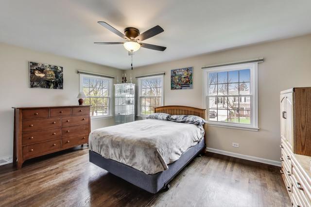 613 Michelline Ln, Northbrook, IL 60062 - bedroom featuring multiple windows, dark wood-style flooring, baseboards, and ceiling fan