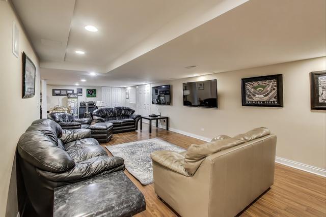 613 Michelline Ln, Northbrook, IL 60062 - living area featuring light wood-style floors, baseboards, recessed lighting, and a tray ceiling