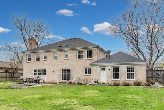 613 Michelline Ln, Northbrook, IL 60062 - rear view of property featuring a chimney and a patio area