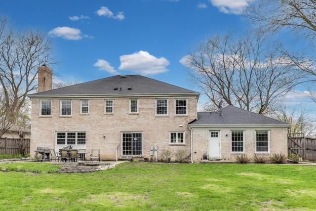 613 Michelline Ln, Northbrook, IL 60062 - back of property featuring a chimney, a patio area, and brick siding