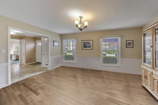 613 Michelline Ln, Northbrook, IL 60062 - spare room with a chandelier, plenty of natural light, and wainscoting