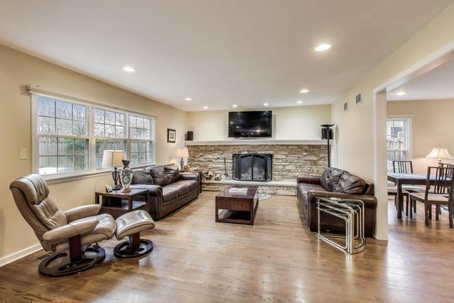 613 Michelline Ln, Northbrook, IL 60062 - living area with wood finished floors, healthy amount of natural light, recessed lighting, a fireplace, and baseboards