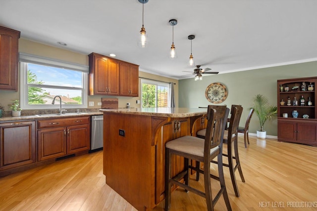 1035 Warwick Cir N, Hoffman Estates, IL 60169 - kitchen featuring stainless steel dishwasher, a breakfast bar area, light wood finished floors, ornamental molding, and recessed lighting